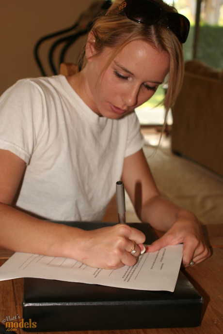 Fresh teenie yellow-haired stands undressed before signing undressed model release forms