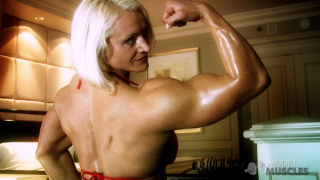 Slovenian bodybuilder Brigita Brezovac shows off her humongous biceps & cleavage