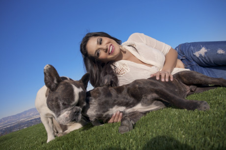 Sexy and cute brunette doll Sunny Leone poses outdoors in tight jeans