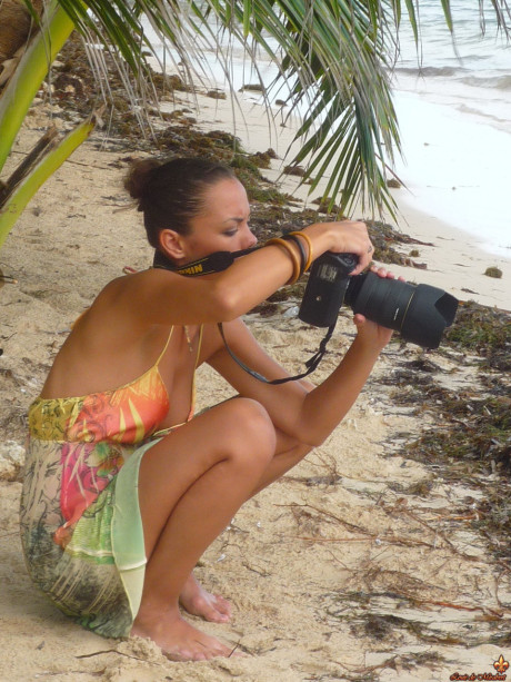 Beautiful girls work free of their swimwear while modeling on a tropical beach