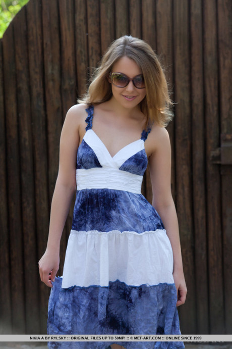 Smiley faced young Nikia A removing dress for outdoor glamour spread