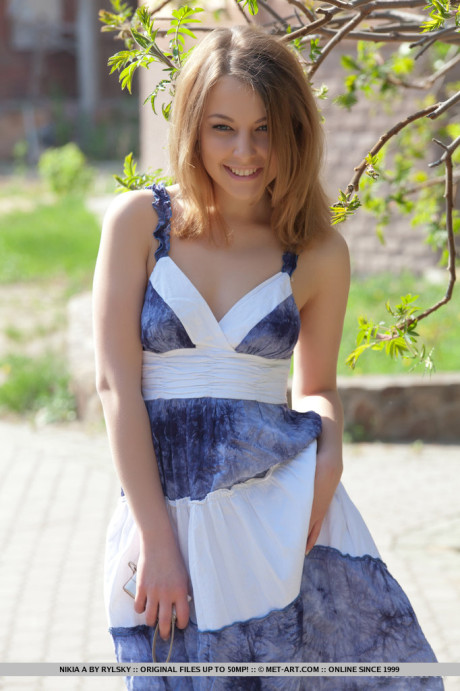 Smiley faced young Nikia A removing dress for outdoor glamour spread