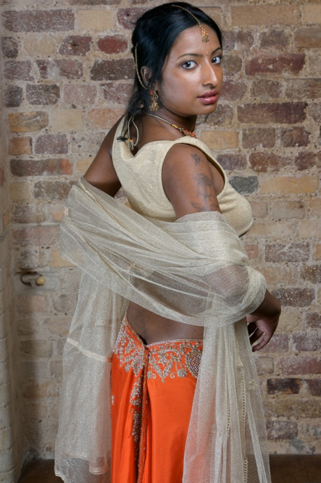 Indian model with tattoos exposes her firm breasts in traditional clothing