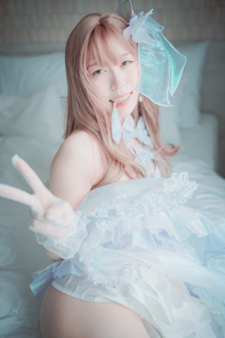 Saucy South Korean skank girlfriend broad posing seductively in her white dress and leggings