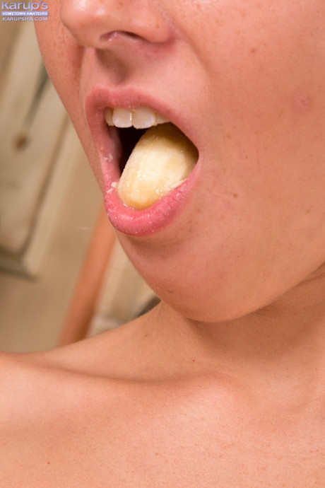 Undressed teenage hottie Lily Banks playing with banana in the kitchenette