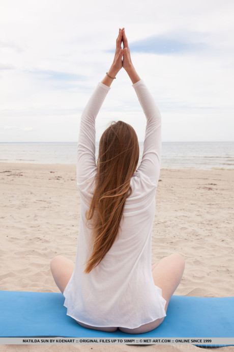 Caucasian teenie Matilda Sun gets undressed while doing yoga at the beach