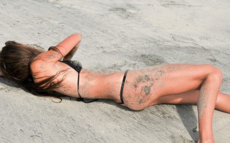Tall pornstar Sofie Marie shows off her huge behind & tiny its on the sandy beach