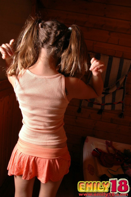 Adorable teenie goes bare-breasted while wearing sweet panties and socks