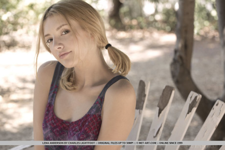 Teen first timer Lena Anderson vaunts her lithe body under a tree outside