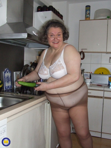 Chunky old housewife Birgid masturbates with a cucumber in the kitchen