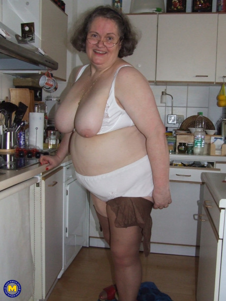 Chunky old housewife Birgid masturbates with a cucumber in the kitchen