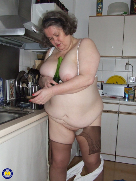 Chunky old housewife Birgid masturbates with a cucumber in the kitchen