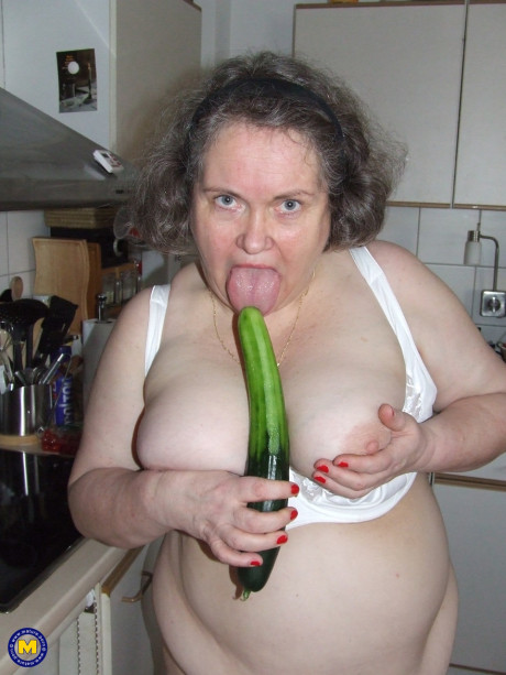 Chunky old housewife Birgid masturbates with a cucumber in the kitchen