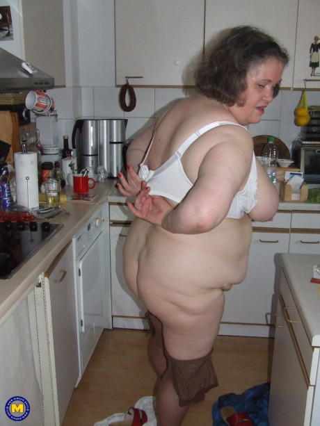 Chunky old housewife Birgid masturbates with a cucumber in the kitchen