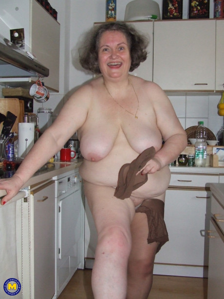 Chunky old housewife Birgid masturbates with a cucumber in the kitchen