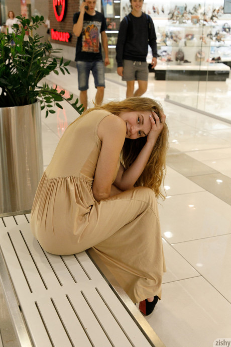 Ukrainian babe Regan Budimir flashes her massive tit while posing at the mall