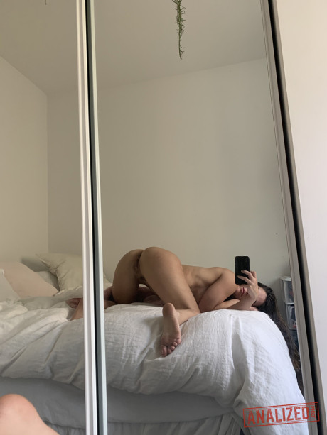 Brunette amateur takes selfies while getting nude in front of a mirror