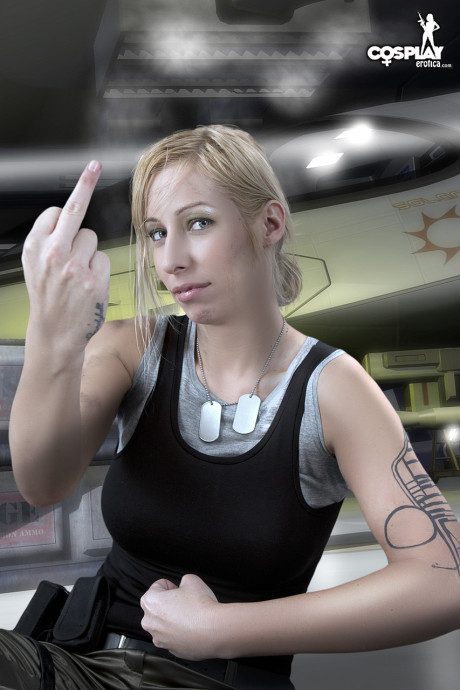 Yellow-haired cosplayer uncovers her firm tits before showing her snatch