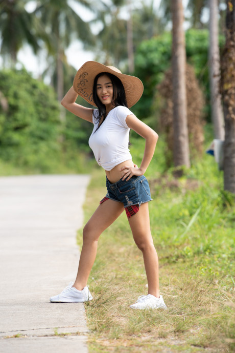 Fresh teenie oriental babe Kahlisa reveals her incredible boobies & oils her body outdoors