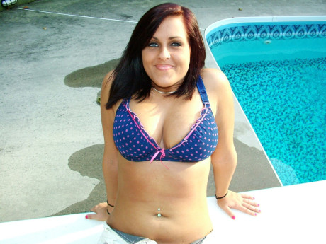 Dark-haired amateur teen Roxy goes unclothed poolside & shows her big titties