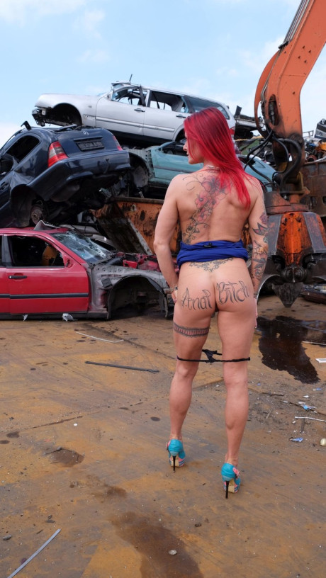 Red Hair MILF with tattoos and fake boobies gets pounded in a junk yard 3some