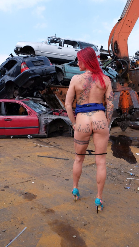 Red Hair MILF with tattoos and fake boobies gets pounded in a junk yard 3some