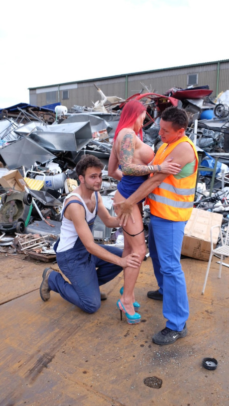 Red Hair MILF with tattoos and fake boobies gets pounded in a junk yard 3some