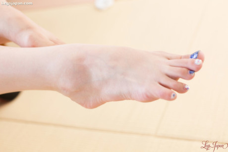 Japanese girl exposes her feet with blue nail polish while masturbating