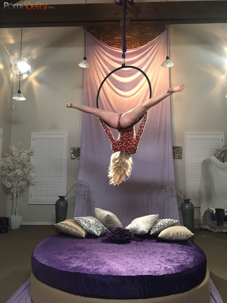 Superb blondy doll Arya Fae doing aerial yoga and showing her breasts and behind