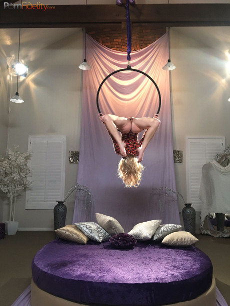 Superb blondy doll Arya Fae doing aerial yoga and showing her breasts and behind