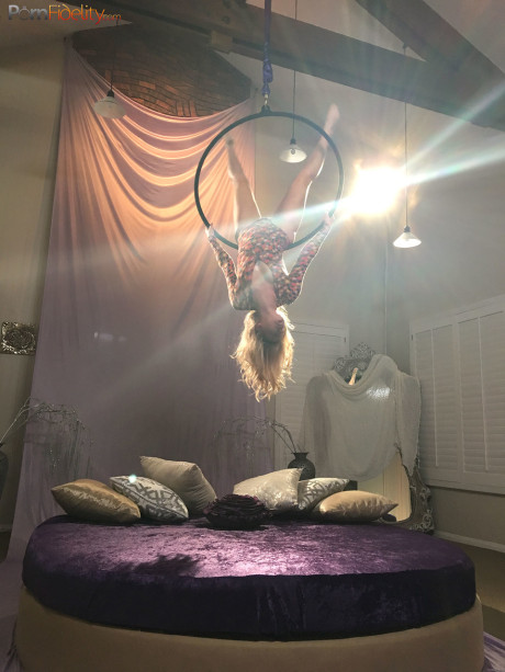 Superb blondy doll Arya Fae doing aerial yoga and showing her breasts and behind