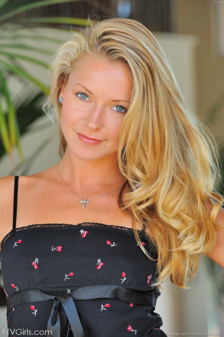 Adorable blondie girl girl woman stands naked outdoors after taking off her dress
