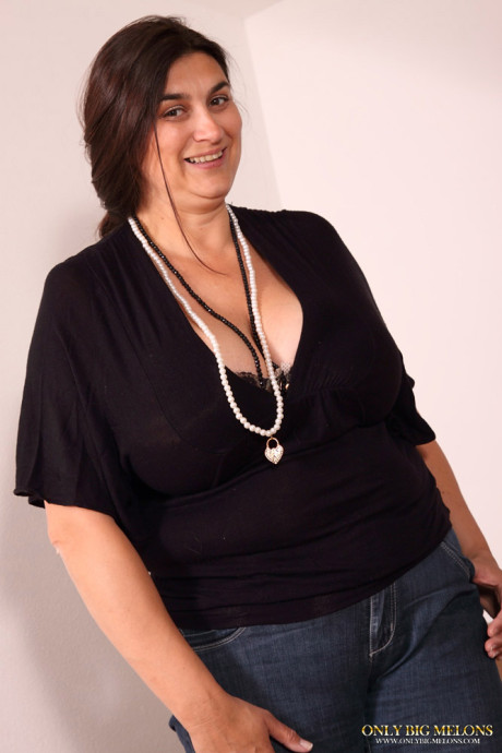 Overweight slut woman releases her monstrous breasts while on a sofa
