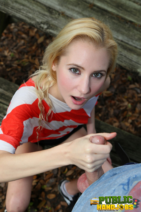 Yellow-haired Odette Delacroix shows her tiny melons while giving a handjob outdoors