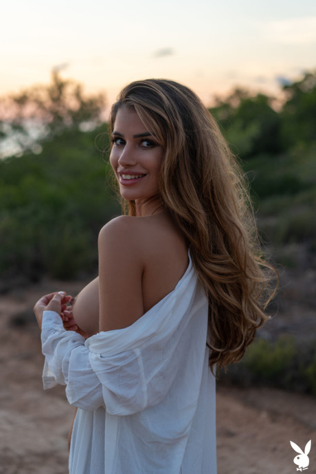 Fresh teen centerfold Laura Schultz shows her beautiful young tits outdoors