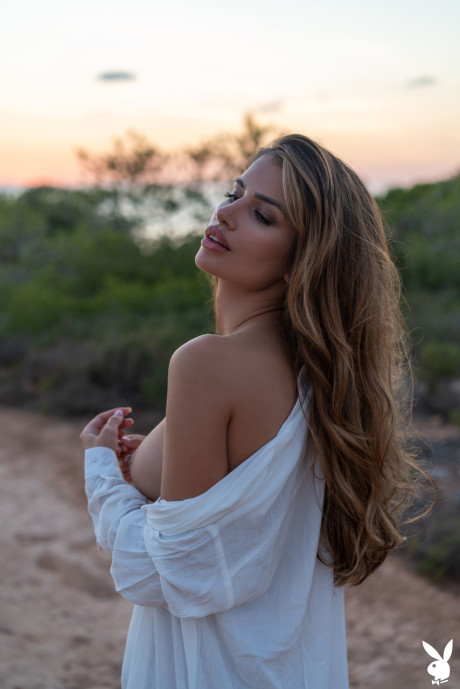 Fresh teen centerfold Laura Schultz shows her beautiful young tits outdoors