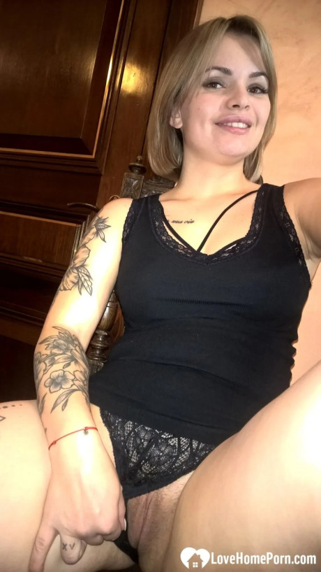 Yellow-haired babe shows her small boobs & her shaved cunt in black undies