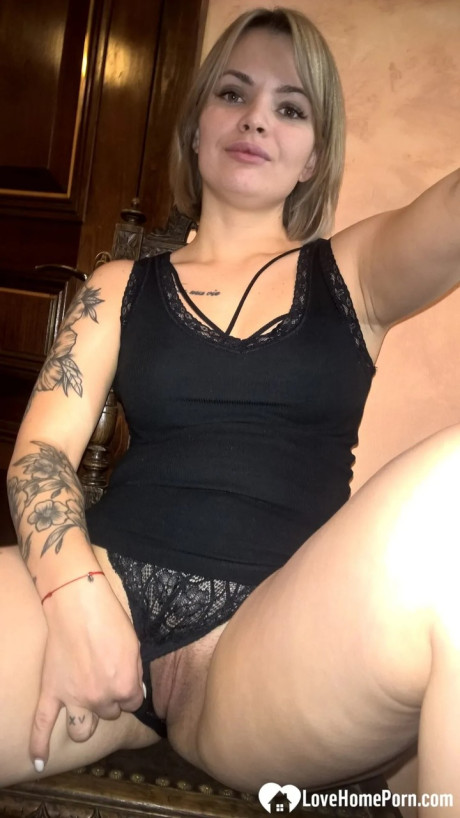 Yellow-haired babe shows her small boobs & her shaved cunt in black undies