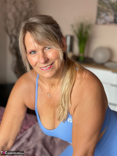 Fit middle-aged woman sports a camel toe before showing her melons and snatch