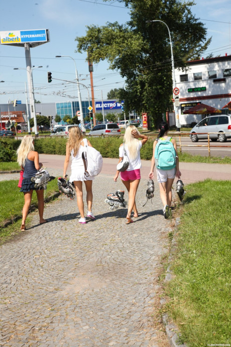 Four charming teens expose their skinny bodies and small titties on roller blades