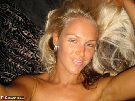 Hot blonde Aussie Jewel displays her large breasts while taking undressed selfies