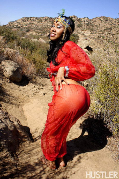 Black harem member Yasmine De Leon strips naked on a dirt trail thru the hills