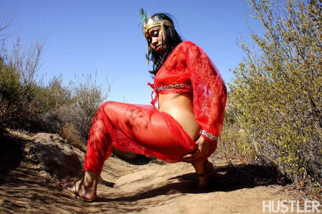 Black harem member Yasmine De Leon strips naked on a dirt trail thru the hills