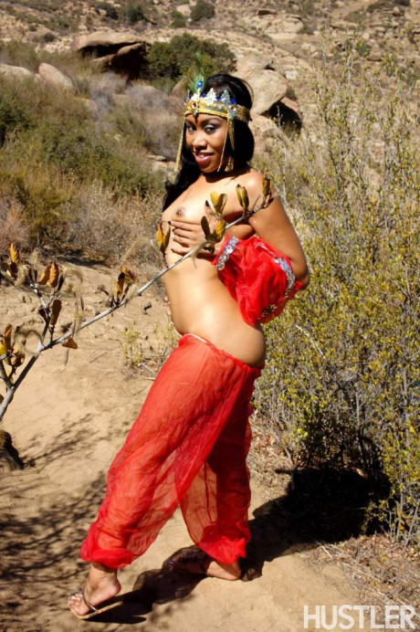 Black harem member Yasmine De Leon strips naked on a dirt trail thru the hills