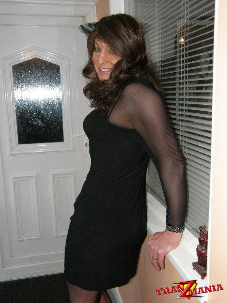 Ravishing brunette crossdresser teasing in a pair of ebony nylons and matching