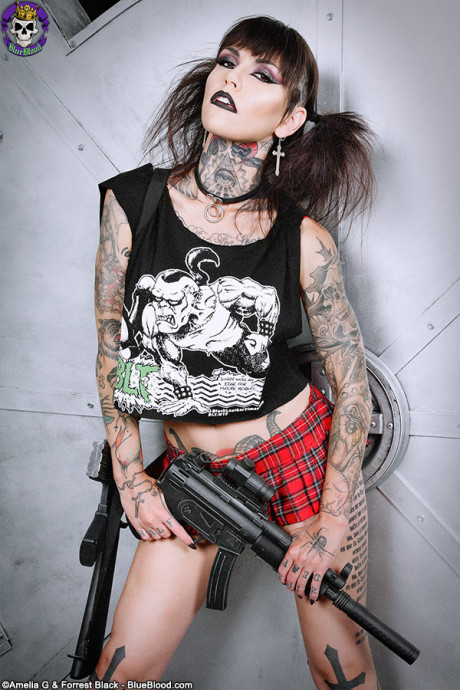 Tattoo enthusiast Malice Mcmunn strips to Doc's while handling guns