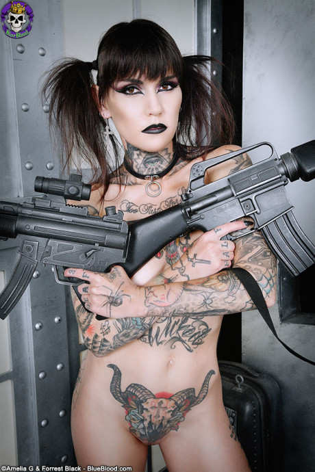 Tattoo enthusiast Malice Mcmunn strips to Doc's while handling guns