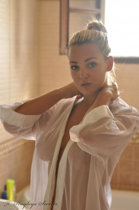 Ravishing blonde girl broad Jodie Gasson pulls on a see thru blouse in the morning