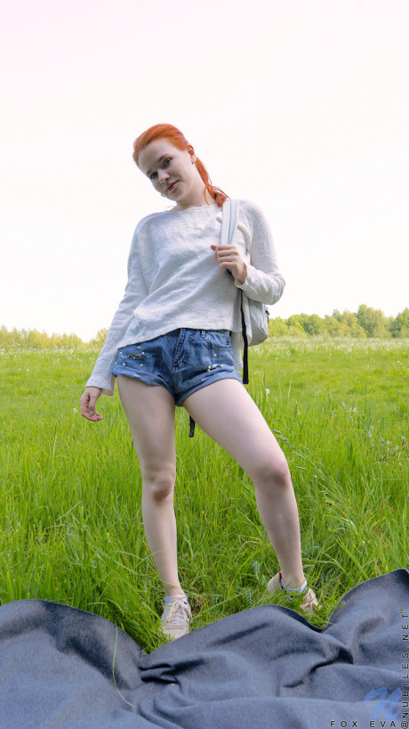 Short redheaded teen Fox Eva stripping and masturbating outdoors
