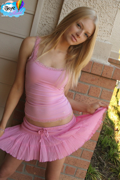 Natural blondy teen Skye Model flashes her thong adorned butt outside her house
